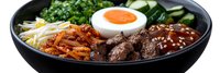 Korean bibimbap bowl with marinated beef, soft boiled egg, fresh vegetables, bean sprouts and spicy sauce served in black ceramic bowl.