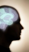 Silhouette of male head in profile with glowing brain and circuit board patterns representing artificial intelligence, neural networks, and digital technology innovation for tech and science concepts.