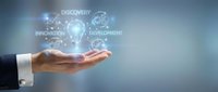 Businessman hand holding glowing digital icons with discovery, innovation, and development text, representing business growth and technology solutions.