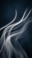 Abstract flowing white smoke waves on dark blue background creating elegant dynamic motion for modern design projects and digital art applications.