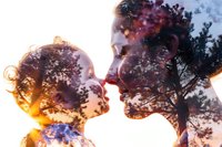 Double exposure portrait of mother and child silhouettes blended with sunset forest scene, creating ethereal connection between parent and offspring in nature.