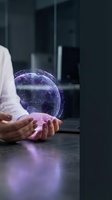 Businessman holding glowing digital globe with network connections, representing global technology, international business, and worldwide digital connectivity in modern office environment.