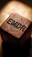 Vintage wooden rubber stamp with END text engraved on surface, close-up macro photography with warm lighting for business and office concepts.