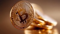 Golden cryptocurrency coin with bitcoin symbol on blurred background showing digital money concept and blockchain technology investment.