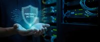 Cybersecurity professional holding glowing firewall shield icon with circuit patterns, representing network protection and digital security infrastructure defense.