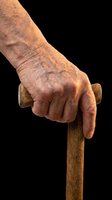 Elderly hand gripping a wooden walking cane, isolated on transparent background. Ready for healthcare, senior care clipart, stickers, t-shirt design, and print on demand use.