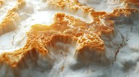 Macro view of abstract golden terrain with crystalline formations and dramatic light effects creating depth and texture on white surface. Artistic landscape concept.