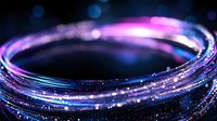 Glowing neon spiral light trail with sparkles and bokeh effects on dark background, creating magical atmosphere with pink and blue colors. Abstract motion blur.