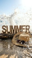 Summer word letters with straw hat and sunglasses on wet beach sand, ocean waves splashing dramatically in bright sunlight.