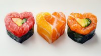 Heart shaped sushi rolls with tuna, salmon, and cucumber on white background, colorful Japanese cuisine arrangement for romantic dinner or Valentine menu.