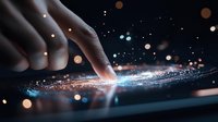 Finger touching digital screen with glowing light effect and bokeh particles, creating futuristic technology interaction on dark background.