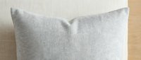 Light gray linen pillow with soft texture against neutral background, suitable for home decor, interior design, and bedding product photography.