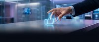 Businessman hand touching glowing like icon on digital table surface in modern office environment with blurred cityscape background, representing social media engagement and digital interaction.
