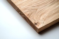 Natural wood cutting board with distinctive grain pattern and organic swirls on white background, minimalist kitchen photography for commercial use.