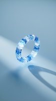 Blue and white geometric crystal ring isolated on light background with shadow, suitable for jewelry design, product mockups, and fashion accessories.