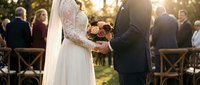 Bride and groom exchanging vows during outdoor wedding ceremony with guests seated in background, golden hour sunlight creating romantic atmosphere.