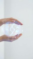 Hands holding glowing holographic sphere displaying DNA helix, fingerprint, and security icons representing biotechnology, genetic research, and digital innovation for healthcare and science applications.