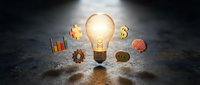 Glowing lightbulb surrounded by business icons including gears, charts, and dollar signs on wet surface representing innovation and financial success.