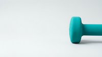 Turquoise dumbbell weight isolated on white background, ready for fitness and gym design projects, workout graphics, and health-related marketing materials.