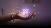 Glowing atomic symbol floating above open palm with magical light particles and energy effects on dark purple background for science technology concepts.