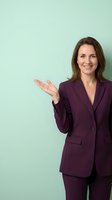 Professional businesswoman in purple suit presenting with open palm gesture against mint green background for corporate marketing materials.