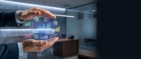 Businessman hands protecting holographic financial data charts and graphs in modern office environment for business analytics and investment planning.