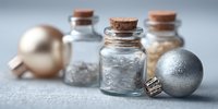 Elegant Christmas ornaments with glass bottles containing glitter and decorative elements for holiday crafting and seasonal home decor projects.