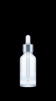 Clear glass dropper bottle with silver metallic cap and rubber pipette, isolated on transparent background, ready for cosmetics, serums, essential oils, and skincare product packaging designs for sublimation and print-on-demand applications.