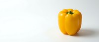 Fresh yellow bell pepper isolated on white background, ready for culinary, food, and design projects.