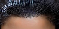 Close-up view of dark spiky hair against skin tone background showing detailed texture and styling pattern for beauty and hairstyling concepts.