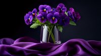 Purple pansy flowers in crystal vase on dark background with flowing silk fabric creating elegant waves and folds, dramatic studio lighting enhances deep violet tones.
