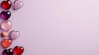 Heart-shaped glass decorations in red, pink and purple shades arranged on soft pink background with copy space, romantic holiday concept for Valentine's Day celebration.