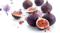 Fresh purple figs with pink flesh isolated on white background with watercolor splashes. Healthy organic fruit for culinary and design projects.