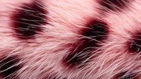 Pink fluffy fur texture with dark spots creating abstract pattern. Natural animal fur background with soft focus and delicate fibers in rose and black colors.