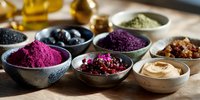 Colorful superfood powders and ingredients in ceramic bowls on wooden table, including acai, matcha green tea, dried berries and hummus for healthy eating.