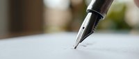 Close-up of elegant fountain pen tip touching white paper surface, ready for writing or signing documents in soft natural lighting.