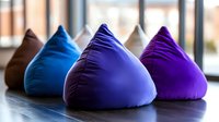 Colorful bean bag chairs in purple and blue tones arranged in modern interior space for comfortable seating and relaxation furniture design.