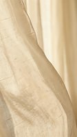 Cream linen fabric with natural texture and soft folds, ideal for interior design, home decor, textile, and fashion projects.