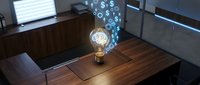 Glowing light bulb with digital dollar signs floating above wooden desk in modern office workspace with laptop and financial data displays.
