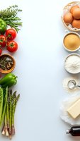 Fresh organic ingredients arranged on white background with copy space for healthy cooking and meal preparation recipes.