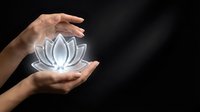 Hands holding glowing lotus flower symbol against dark background, representing spirituality, wellness, meditation, healing, and mindfulness practices.
