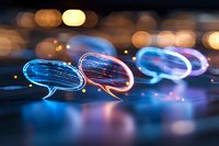 Glowing neon speech bubbles with bokeh lights background creating modern communication concept, social media chat symbols in blue and pink colors.