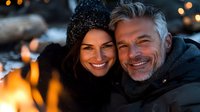 Happy mature couple enjoying winter evening together with warm lights and cozy atmosphere during romantic outdoor date in cold season.