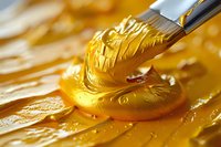 Creamy golden peanut butter texture with knife spreading smooth swirls on surface, macro food photography showing rich detail and glossy consistency.