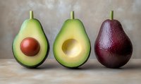 Fresh ripe avocado halves with pit and without pit next to red pear on neutral background, arranged in minimalist style for food photography and design.