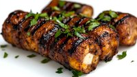 Grilled sausages with herbs on white background, barbecue meat ready for summer cookout and outdoor dining experiences.