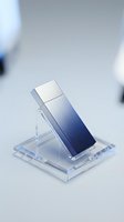 Modern silver USB flash drive on transparent acrylic display stand with gradient blue lighting for technology presentations and product showcases.