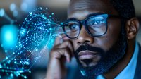 African American businessman with glasses analyzing digital data network hologram in modern office environment for technology presentations.