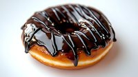 Glazed donut covered in dark chocolate drizzle on white background, fresh baked pastry with rich chocolate topping photographed in closeup macro style.