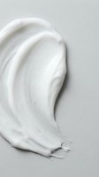 White cream texture smear on neutral background for skincare and cosmetic product advertising and beauty industry marketing materials.